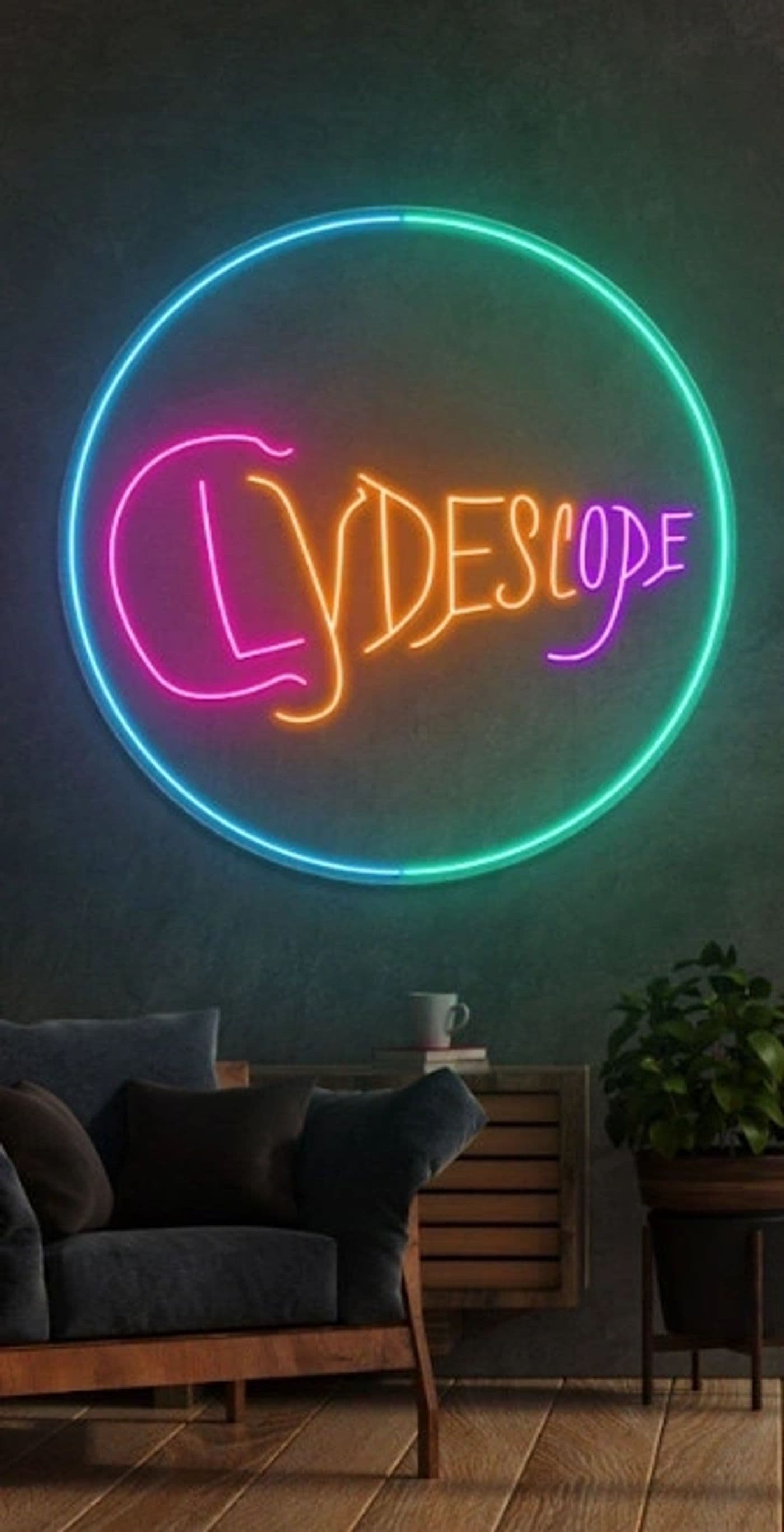 The Clydescope circle logo rendered as a neon sign mounted on a wall