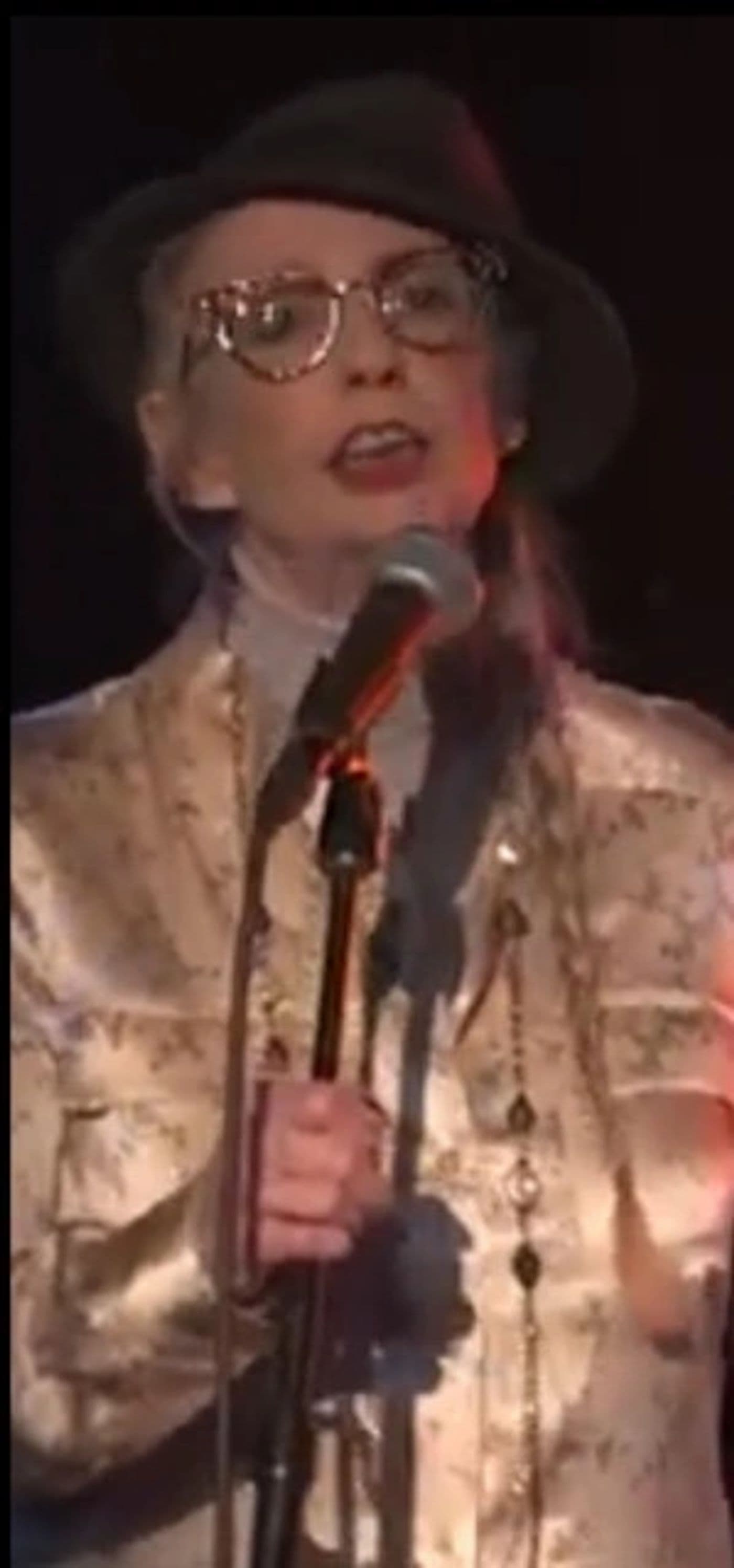 Clydescope vocalist in a hat and glasses singing into the microphone